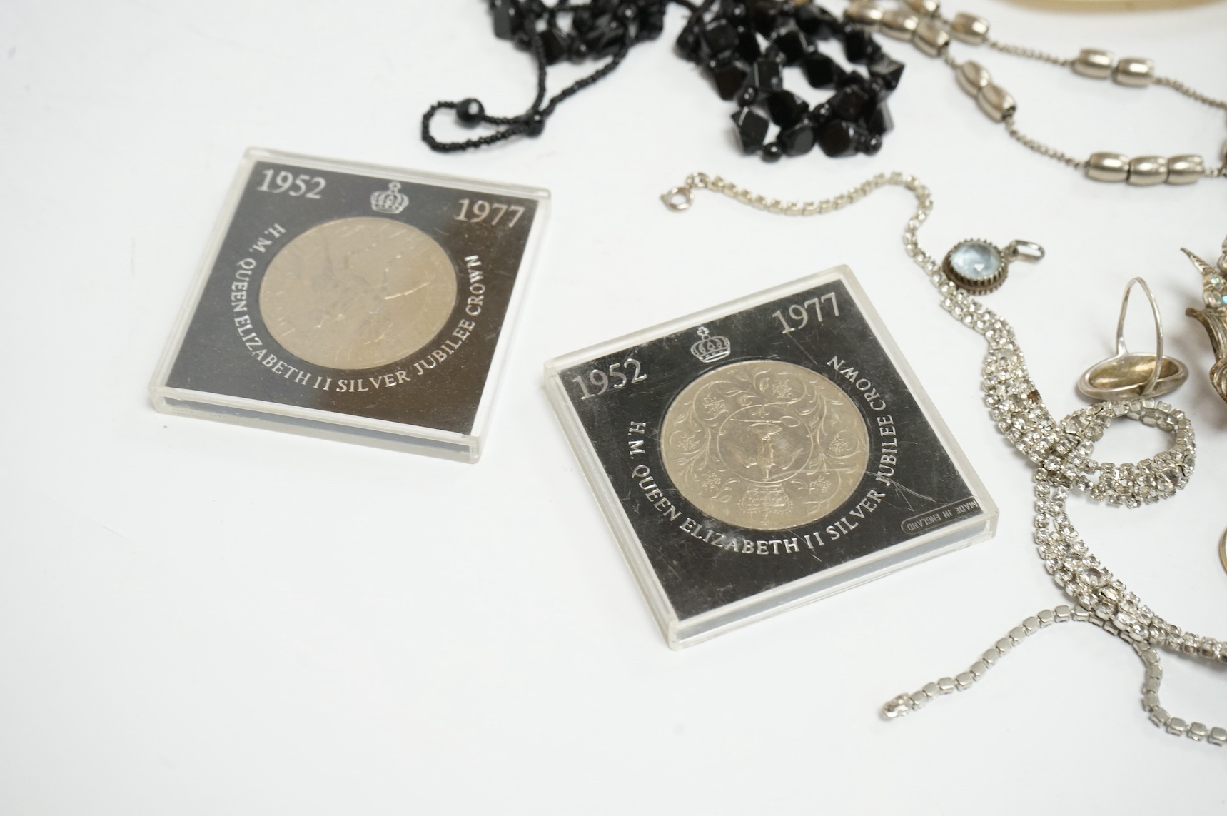 A group of assorted mainly costume and other jewellery including a silver bracelet hung with assorted coins and a Victorian enamelled mourning brooch, together with wrist watches, white metal box etc. Condition - poor to